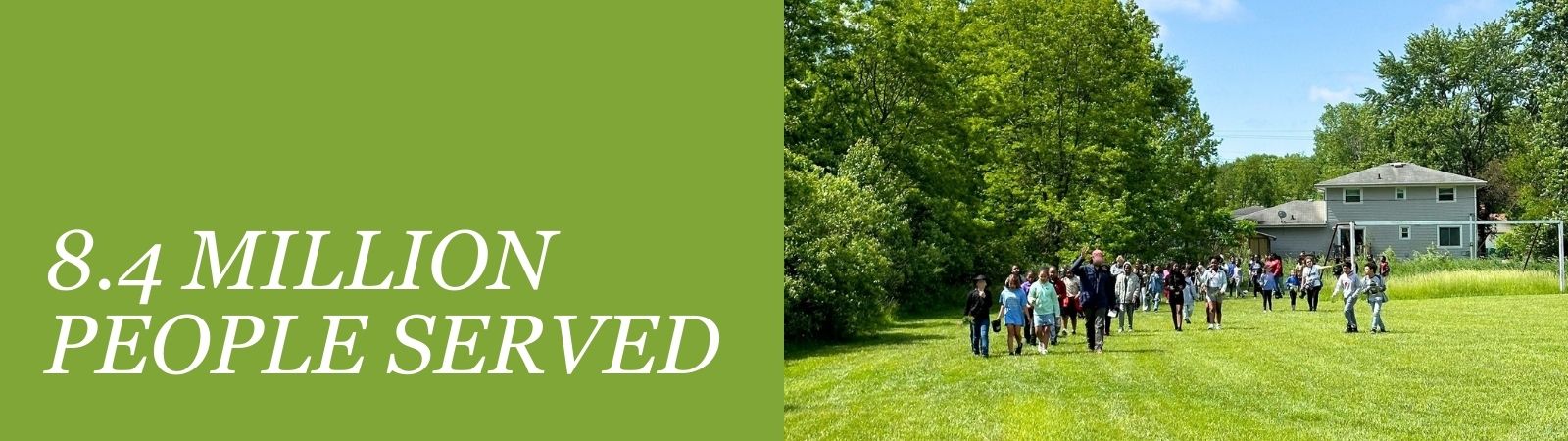 Text reads "8.4 million people served" with group walking in field on tree planting day