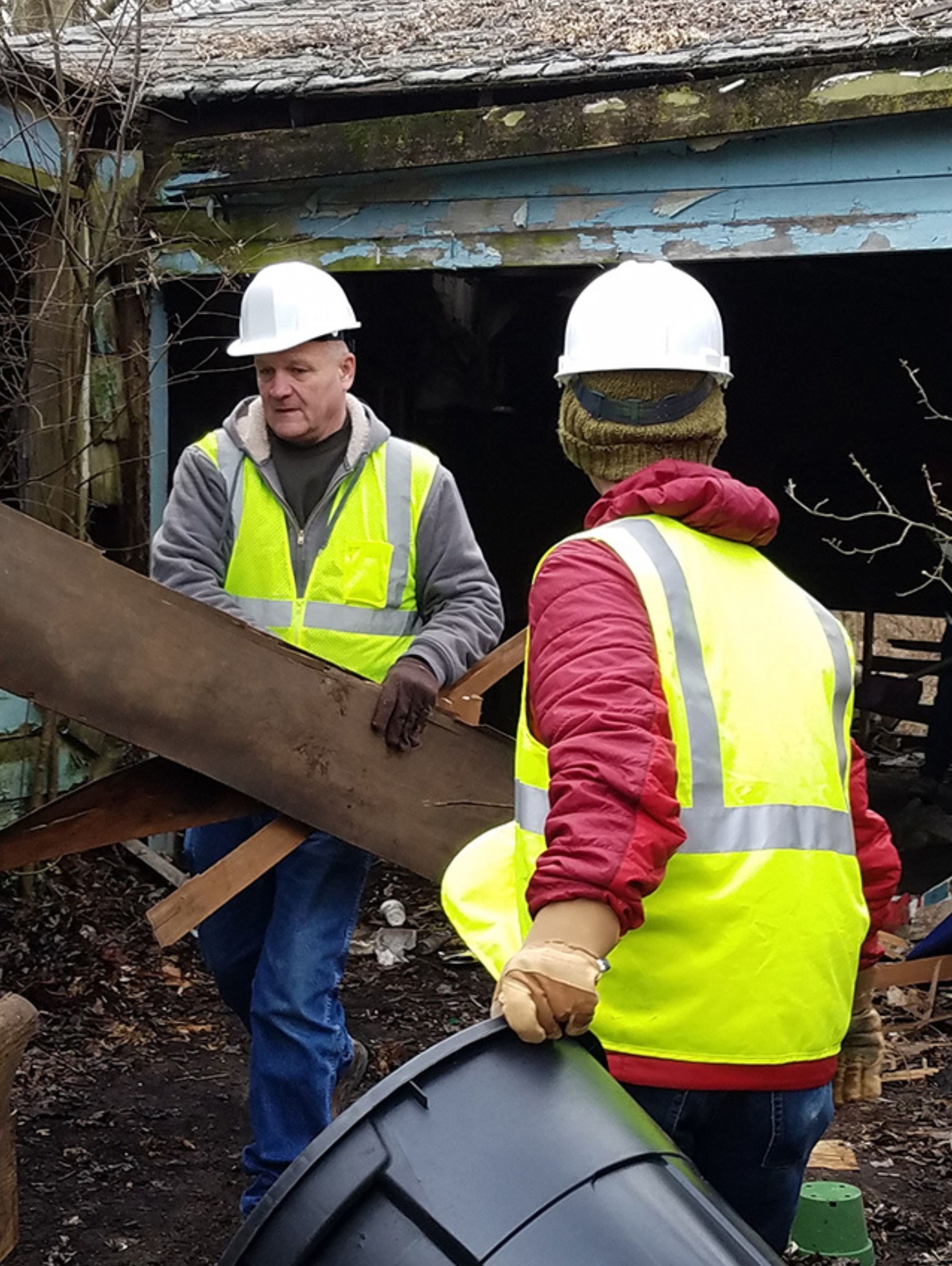Workers deconstructing a building